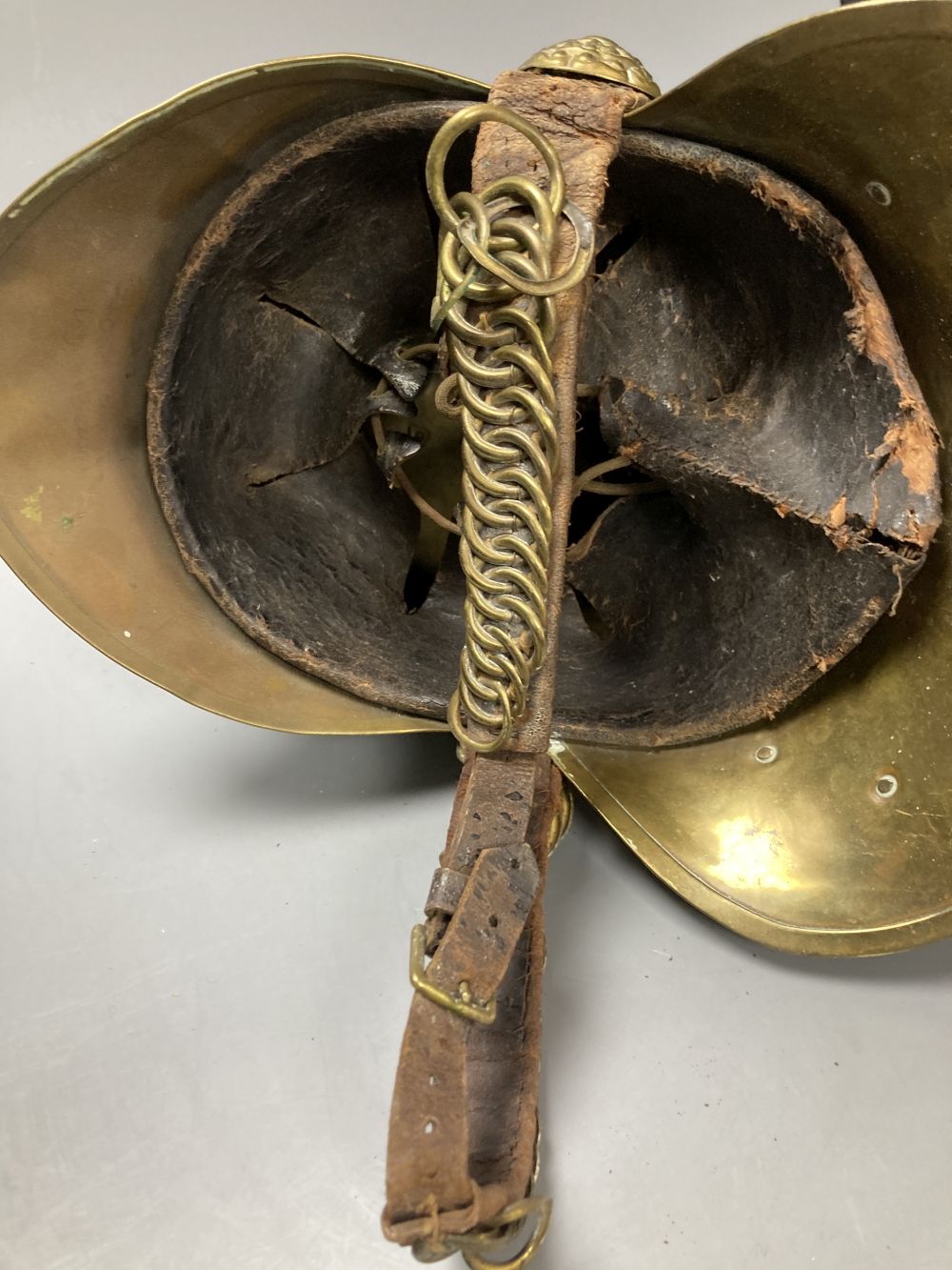 An early 20th century brass firemans helmet, 17cm